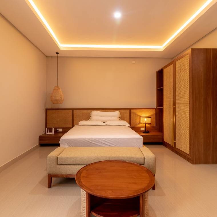 Studio suite with queen bed, caned headboard and rattan wardrobe