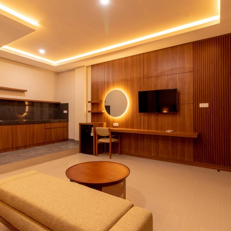 Work desk, television and lit round mirror