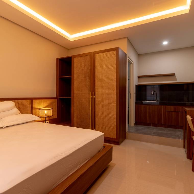 Bed with the desk and kitchenette along one wall