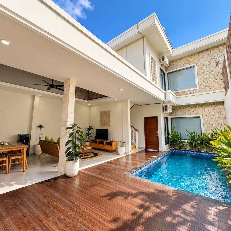 Living room and kitchen opening onto the private pool